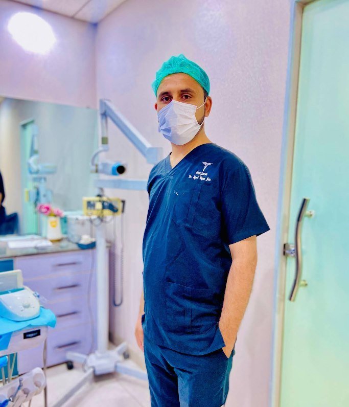 Dr. Syed Ilyas Jan in surgical scrubs at his dental clinic, F-7/1 Islamabad